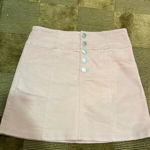 Super chic pink mini skirt with a little stretch and cute button detail.